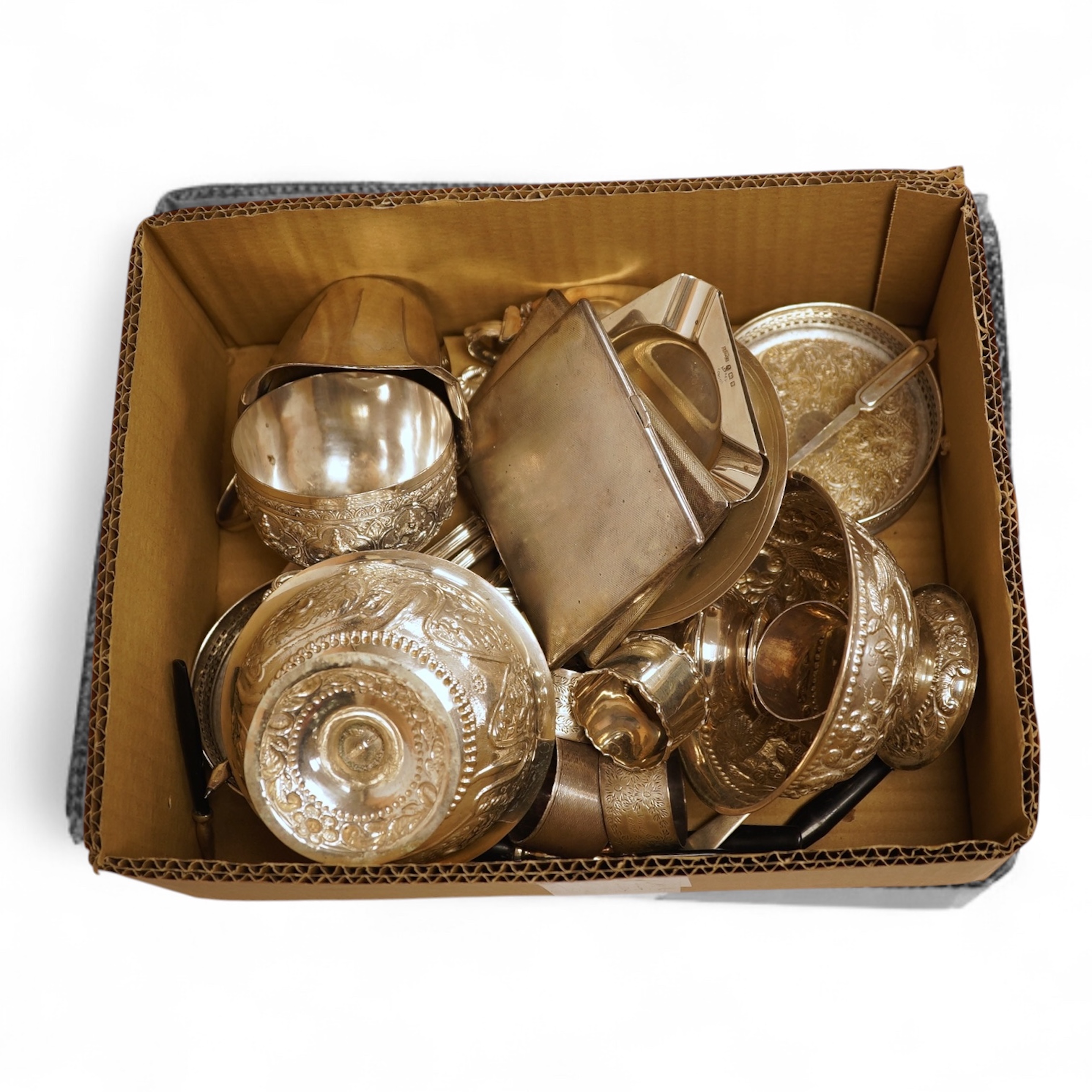 Two George V engine turned silver cigarette cases, largest 12.6cm, together with a pair of Asprey & Co silver ashtrays, a small silver dish, a silver condiment, six silver napkin rings, seven plated items and a quantity